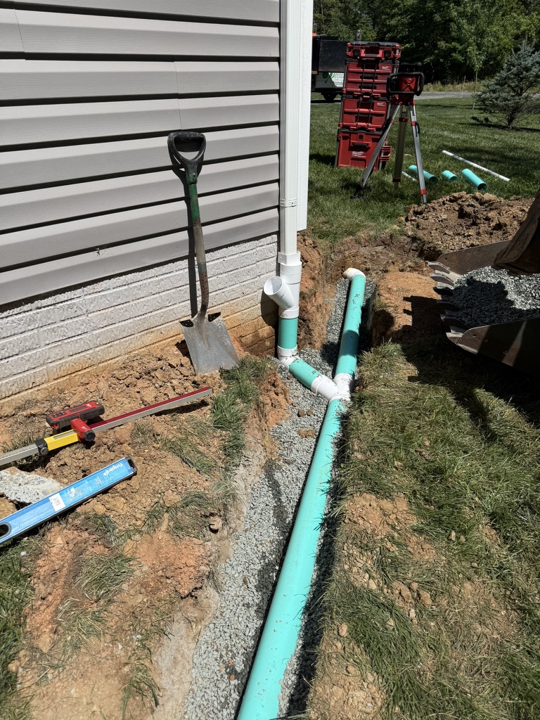 Underground downspout drain installation at Dean Smith’s Northern Virginia home